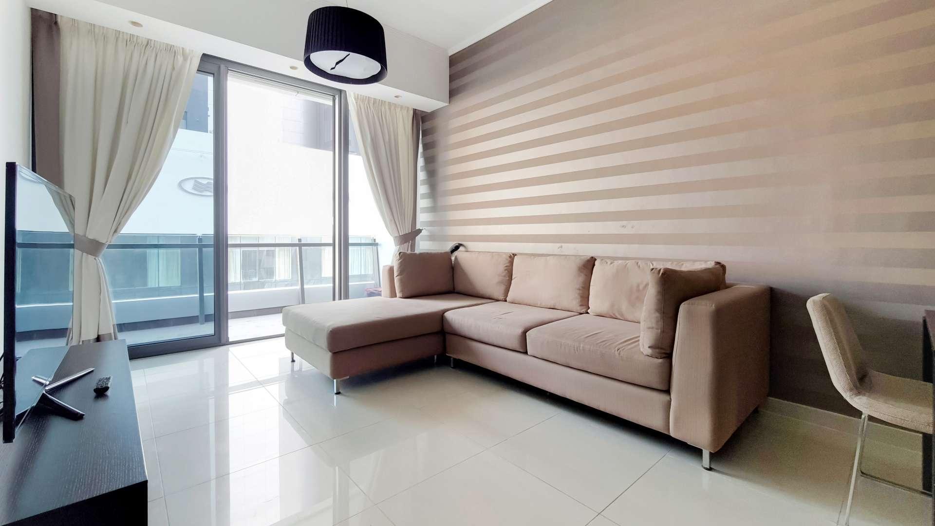 Furnished living room in high-floor Dubai Marina apartment, Silverene, with modern decor and TV