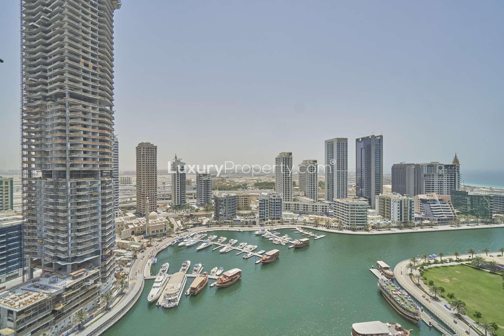 Empty living room in 2-bedroom apartment, Sparkle Towers, Dubai Marina, with large windows