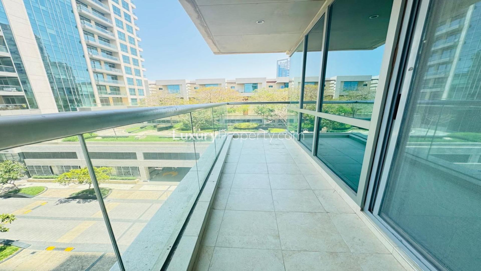 High-rise apartment view with pool and golf course at sunset, The Fairways, Emirates Living