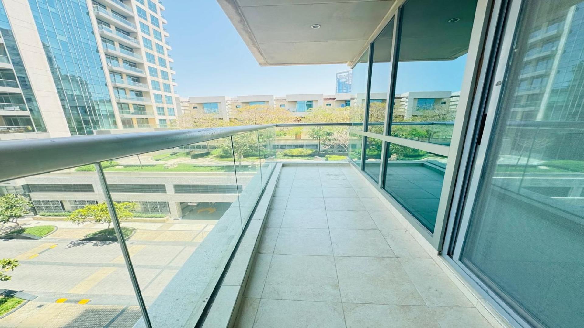 High-rise apartment view with pool and golf course at sunset, The Fairways, Emirates Living