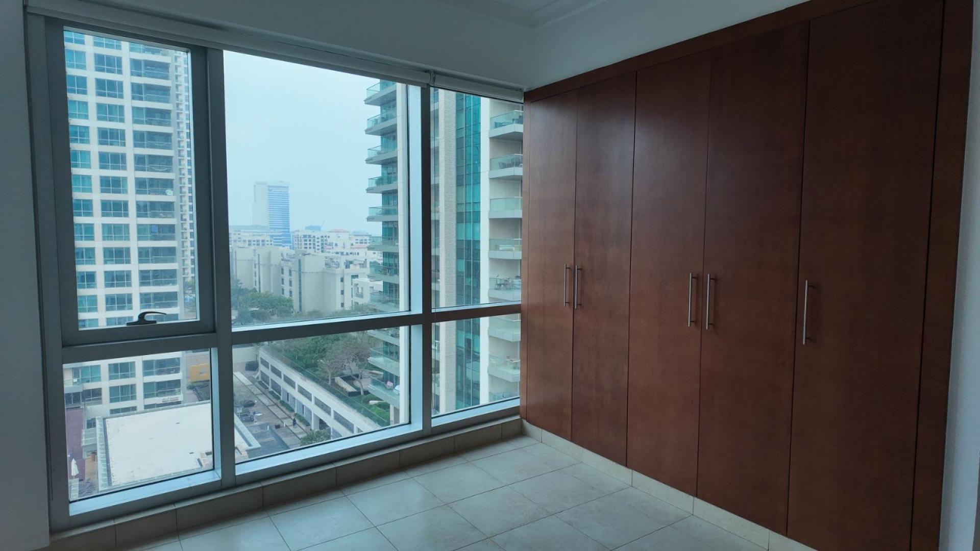 "Spacious apartment with city view in The Fairways, Emirates Living, available for rent.","Bright bedroom with large window and built-in wardrobe in The Fairways apartment, Emirates Living.",Spacious apartment with city view in The Fairways, Emirates Living, available for rent