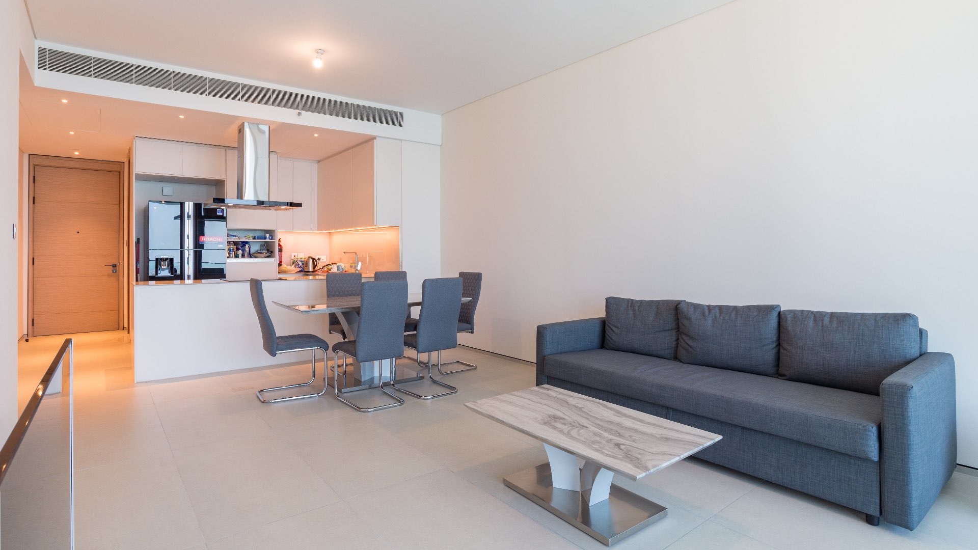 Modern open-plan living and dining area in JBR two-bedroom apartment, The Address Jumeirah