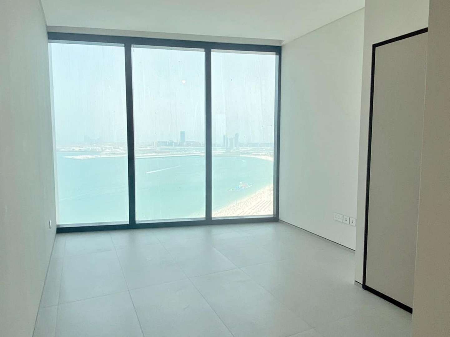 "Stunning sea view from 2-bedroom apartment in The Address Jumeirah Beach Resort, JBR.",Modern apartment interior with large windows, stunning sea view at Jumeirah Beach Residence