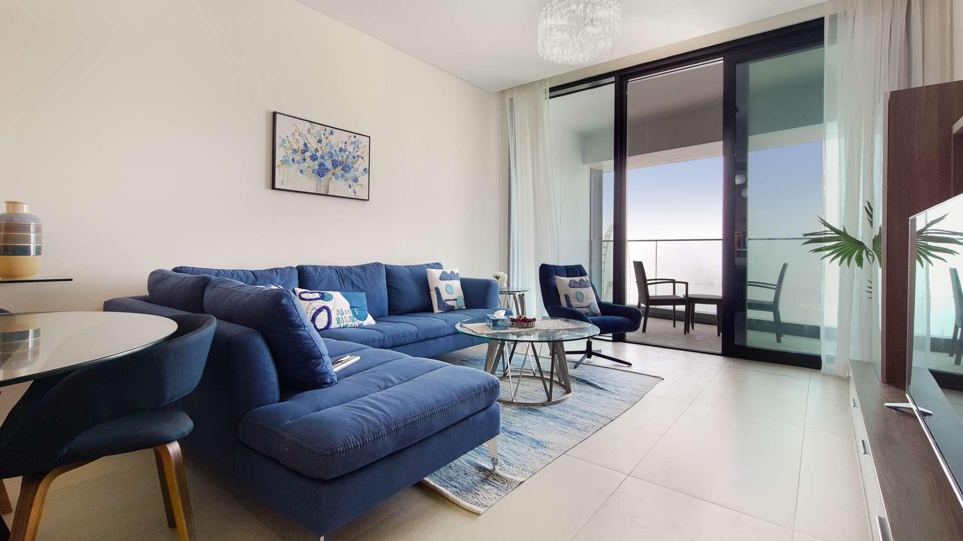 Luxurious Jumeirah Beach Residence apartment living room with modern decor and blue sofa