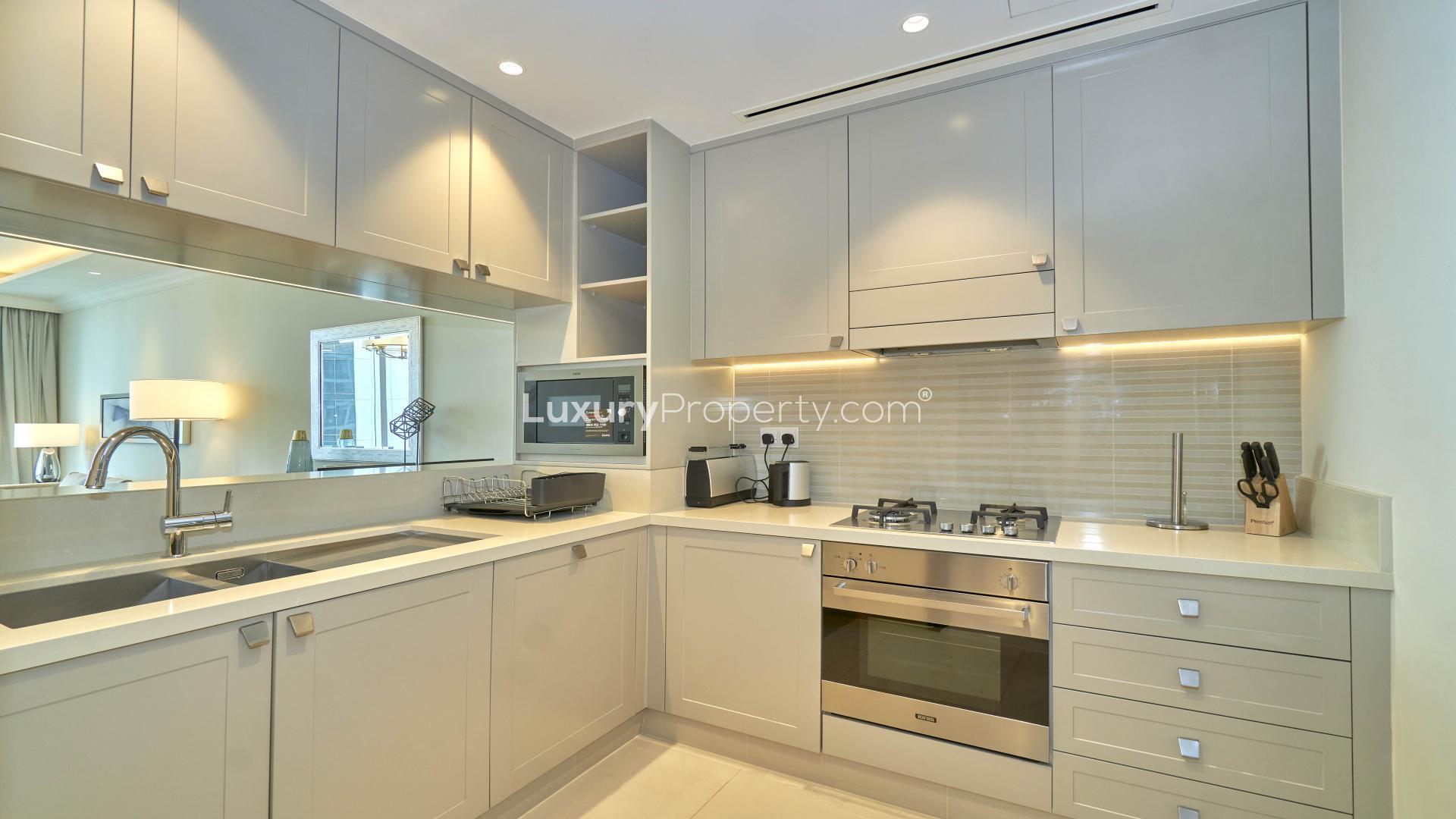 Modern kitchen in Downtown Dubai apartment, featuring sleek cabinetry and built-in appliances