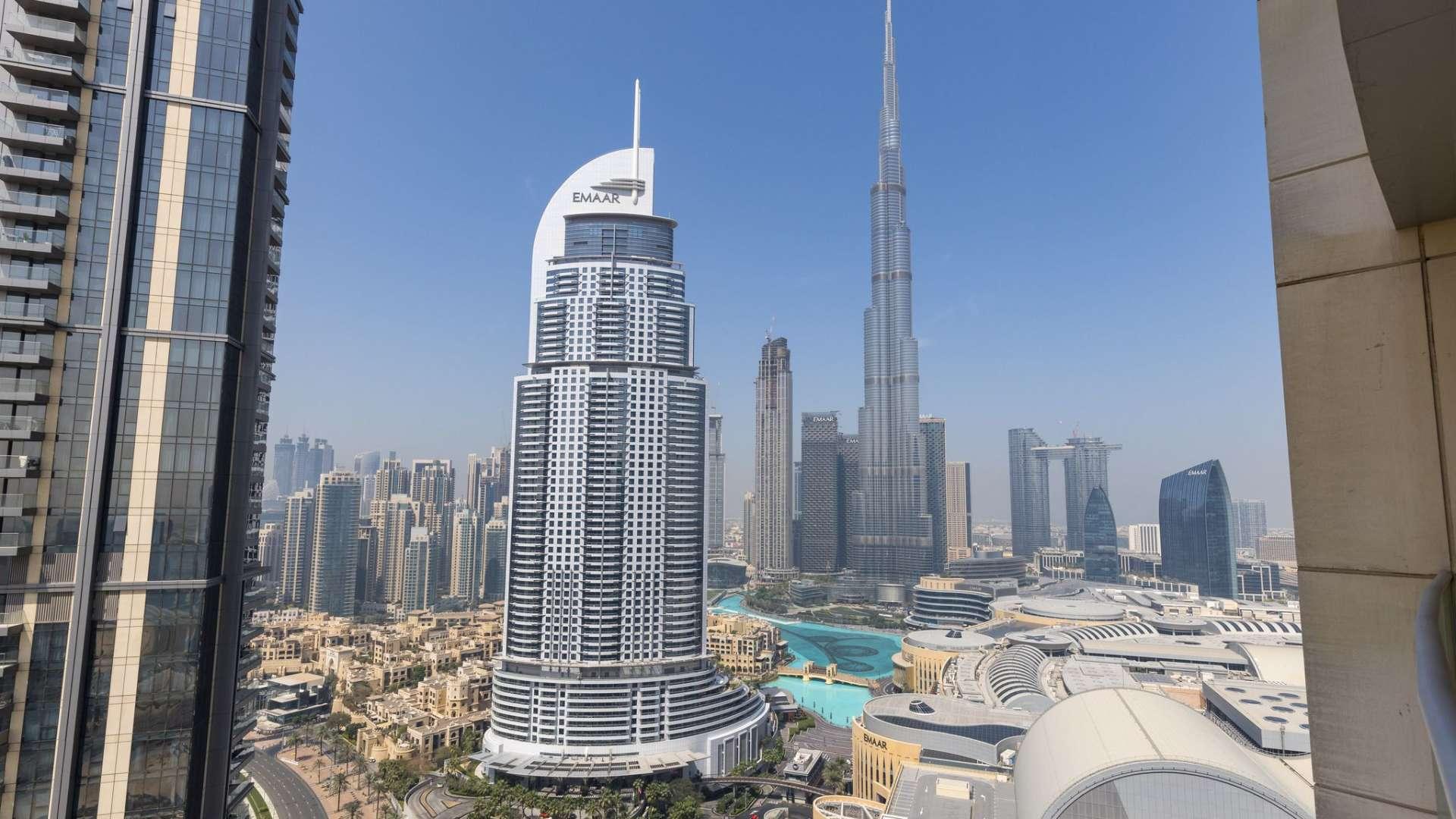 "Spacious living room in Downtown Dubai apartment with Burj Khalifa view and modern decor.",Downtown Dubai apartment view with Burj Khalifa and city skyline, The Address Residence Fountain Views