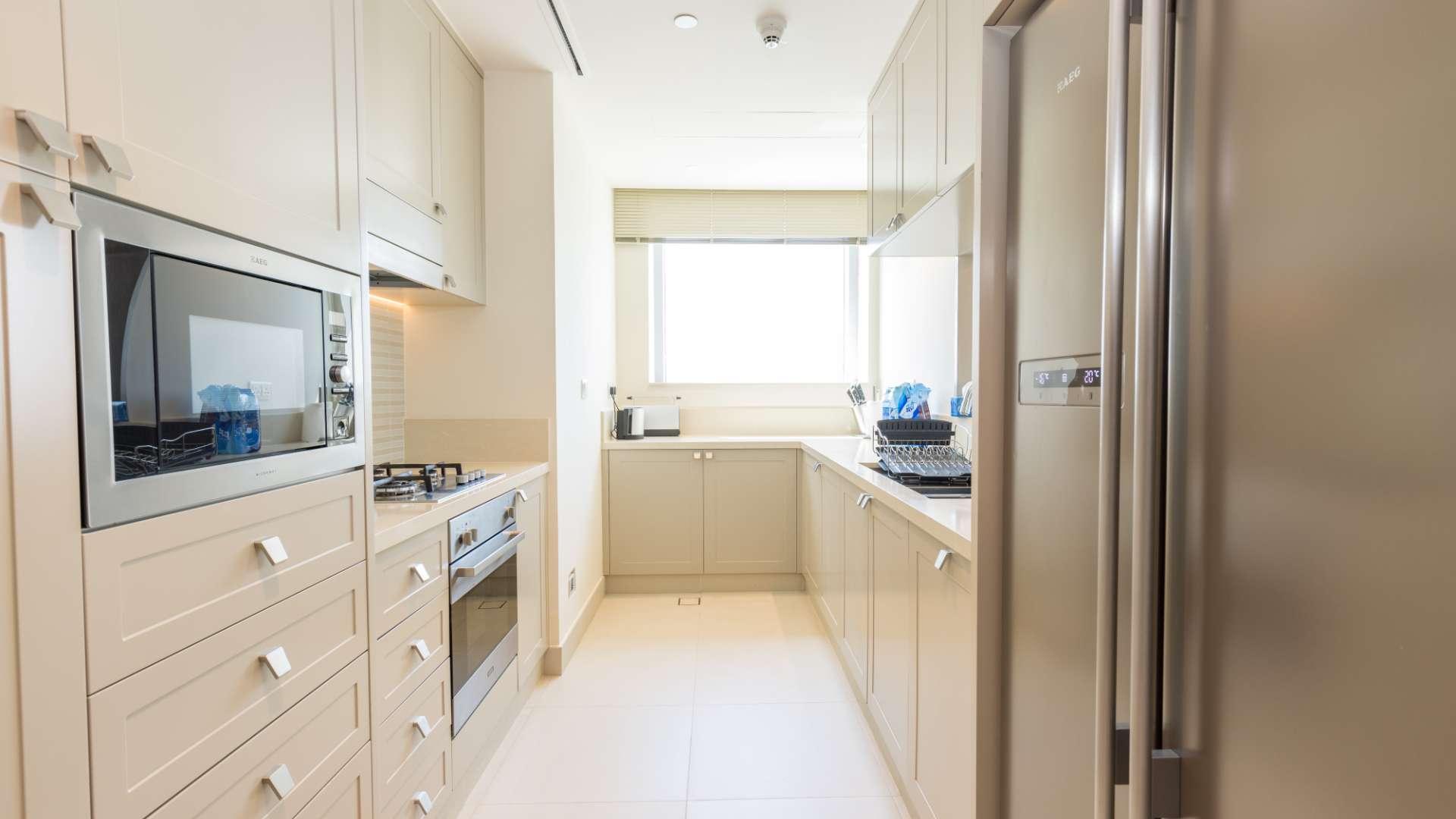 Spacious living room in modern Downtown Dubai apartment with city views through large windows