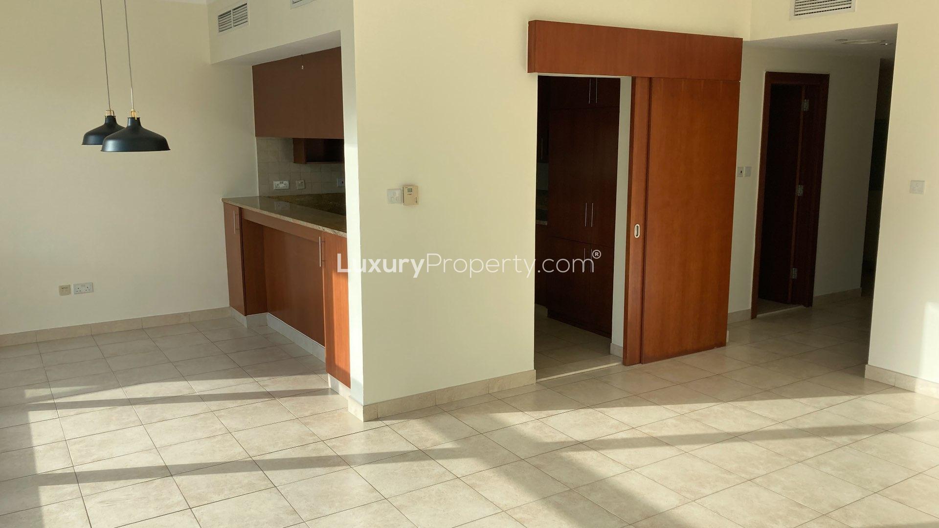 Bright apartment interior with large window, pool view at The Fairways, The Views
