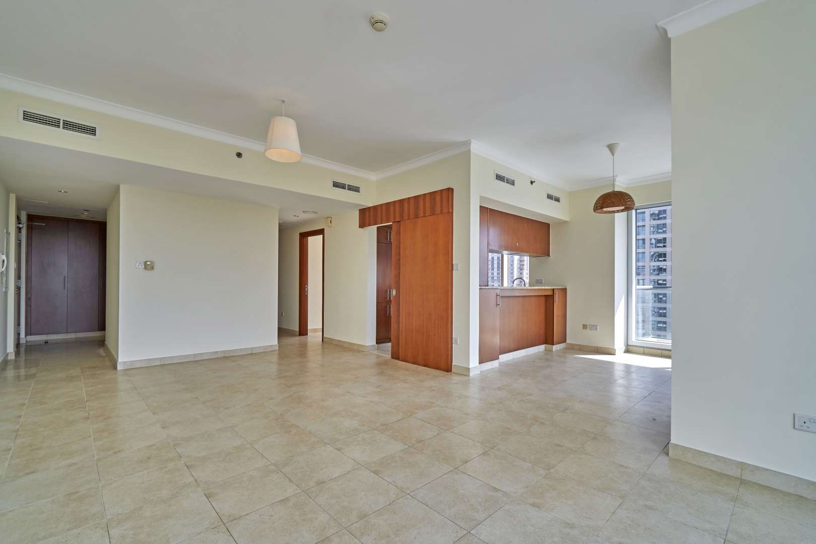 Bright living area with large windows offering stunning views in The Fairways North apartment