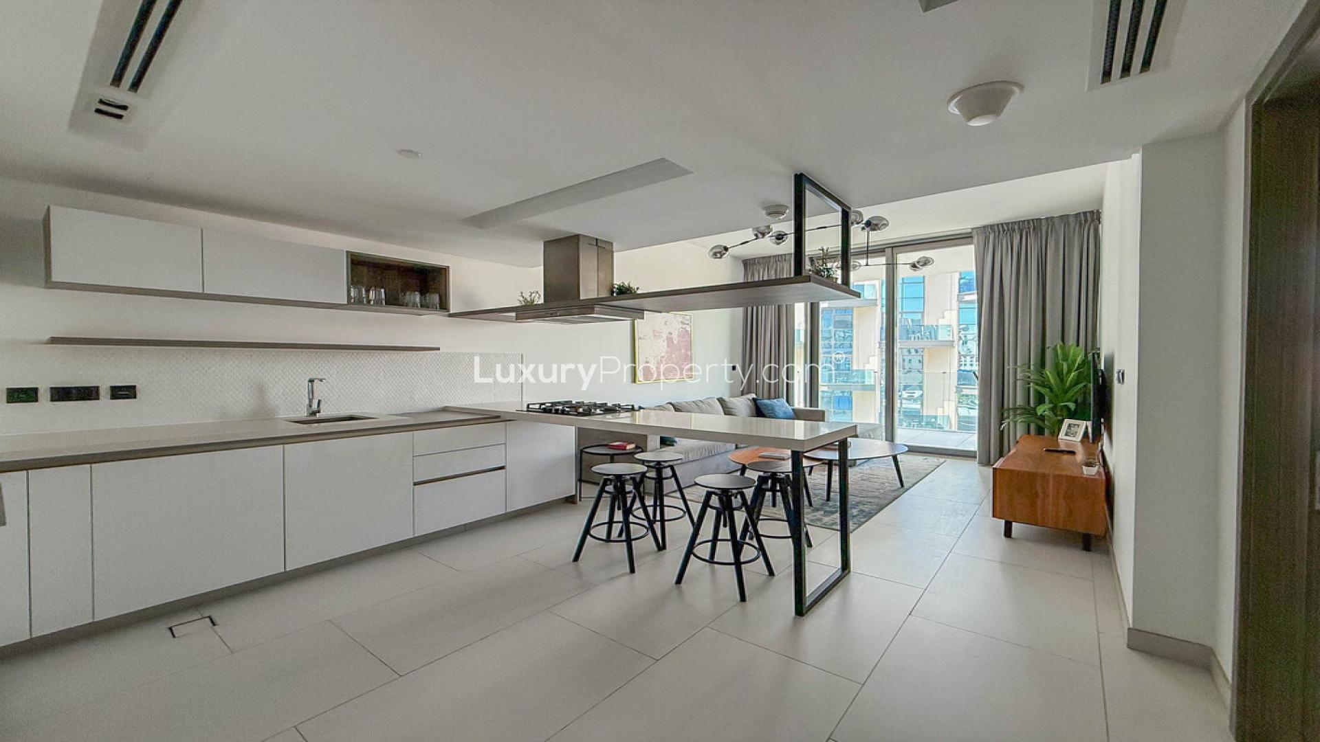 Modern living room in Soho Palm Jumeirah apartment with open kitchen and stylish decor