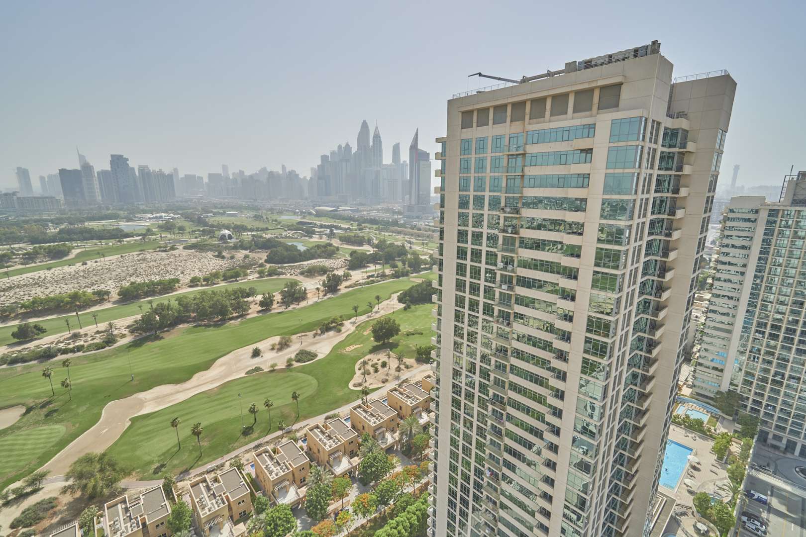 Bright living room with large windows in The Links West Tower apartment, The Views