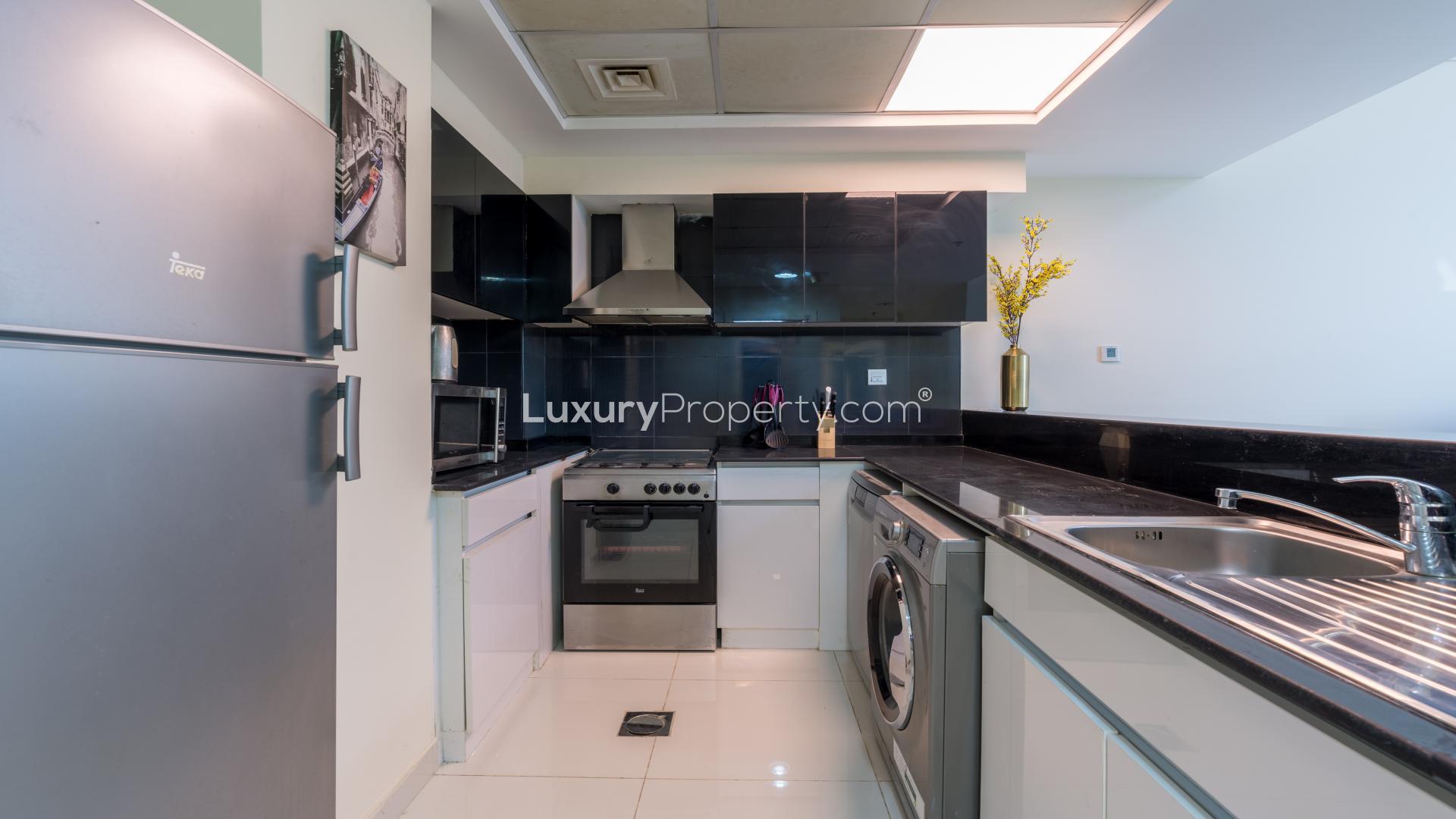 Modern kitchen and living area in 2-bedroom Business Bay apartment for rent, Park Central