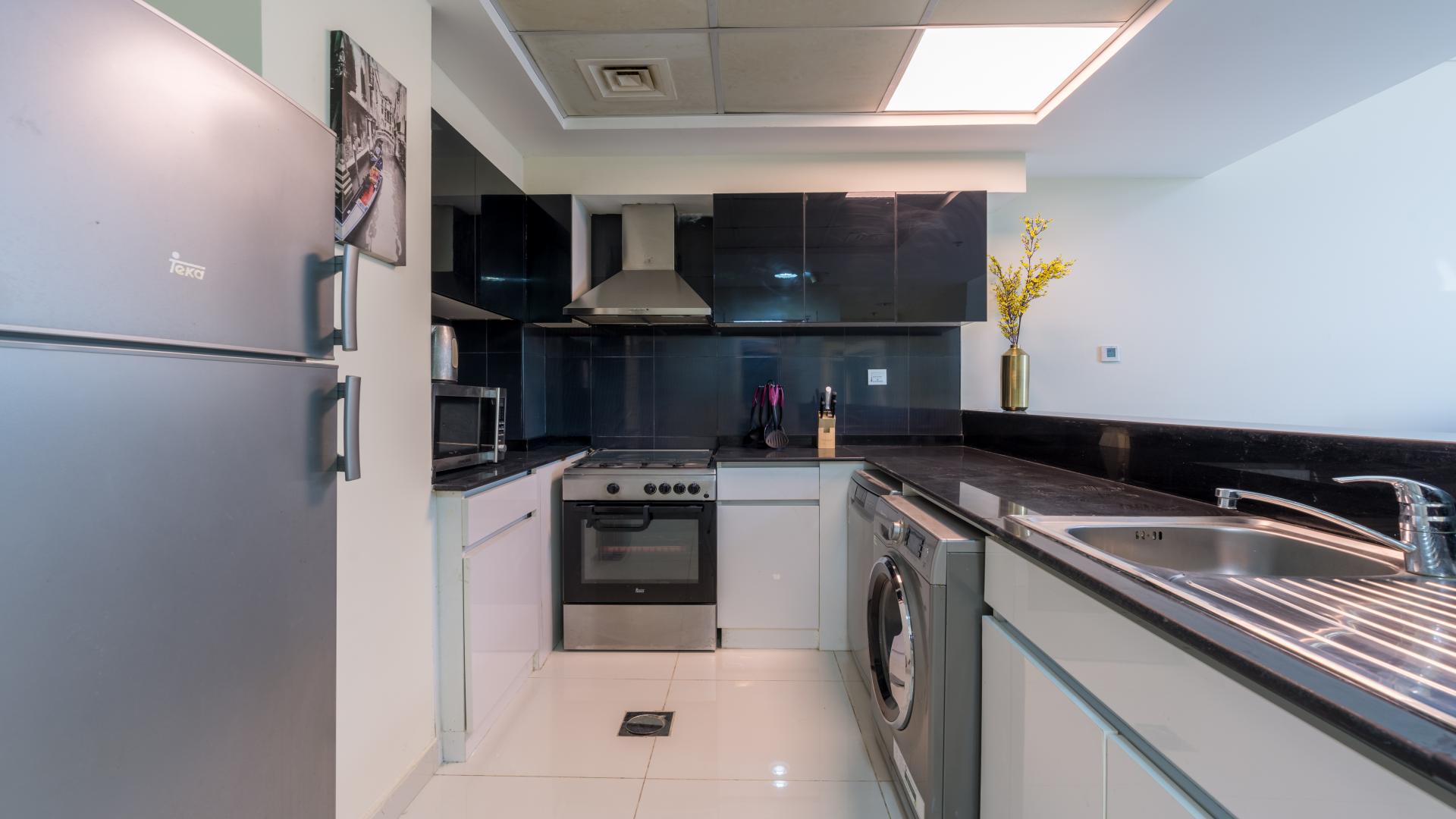 Modern kitchen and living area in 2-bedroom Business Bay apartment for rent, Park Central