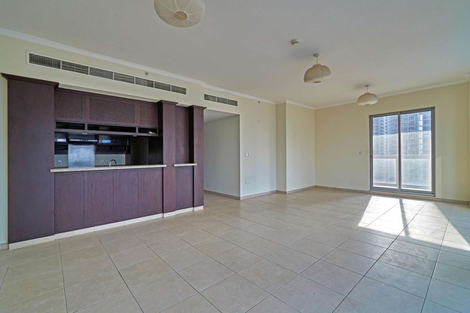 Empty room with large window, city view, in Downtown Dubai apartment for rent