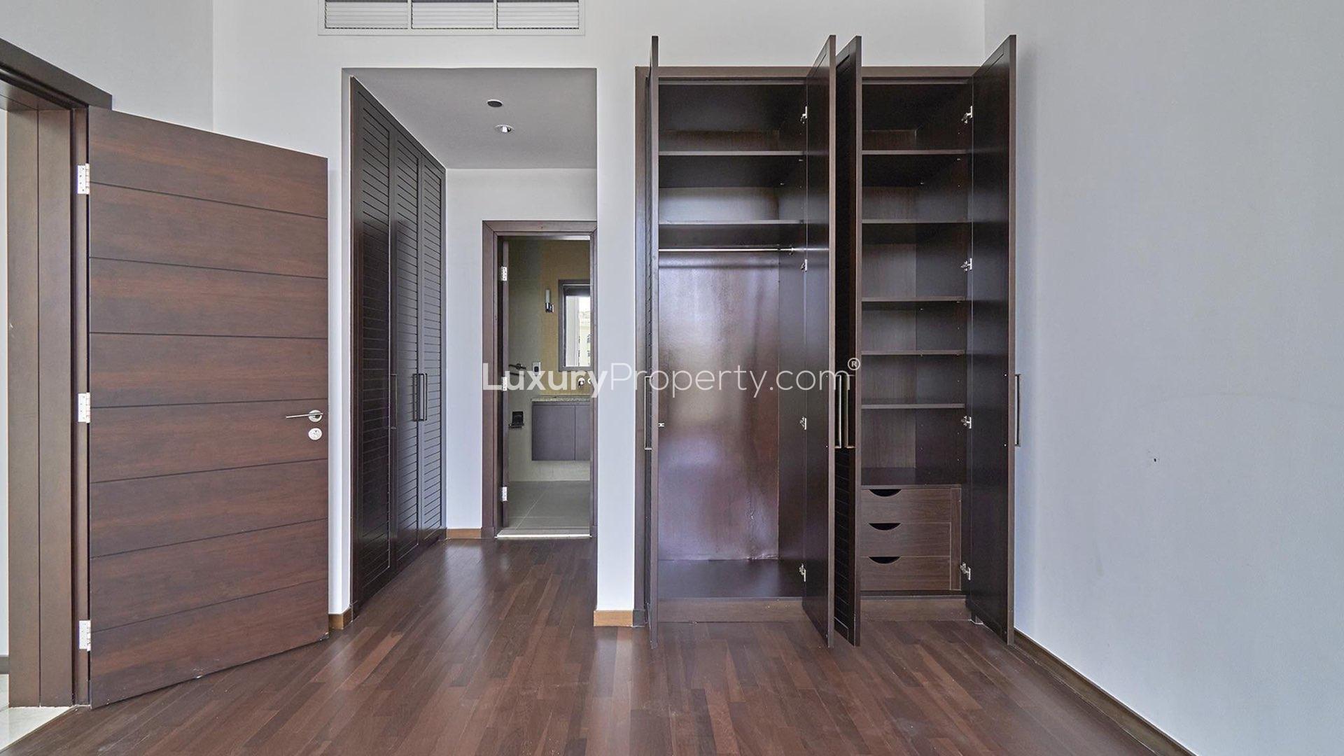 Empty room with large window, wooden floor, Tiara Residences view, Palm Jumeirah apartment