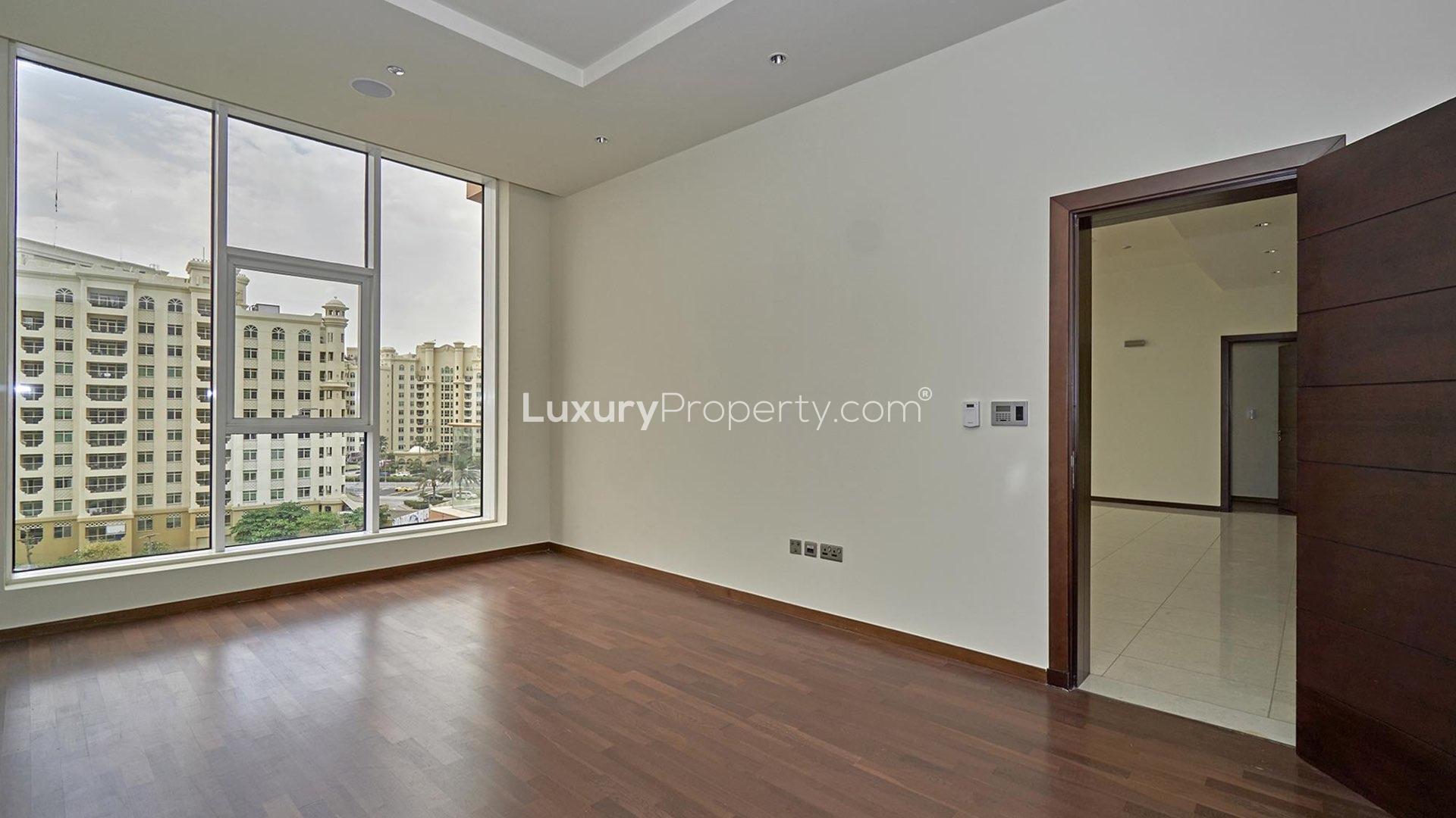Modern kitchen with dark wood cabinets in Tiara Residences apartment, Palm Jumeirah
