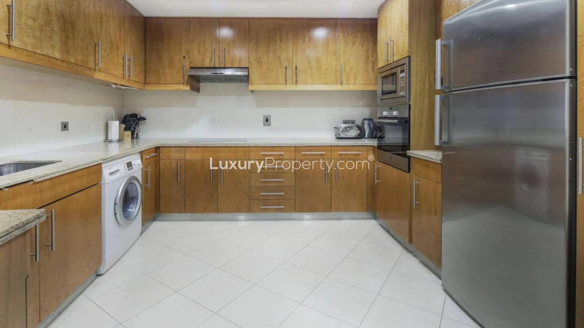 Modern living room in Trident Grand Residence apartment, Dubai Marina, with city view balcony