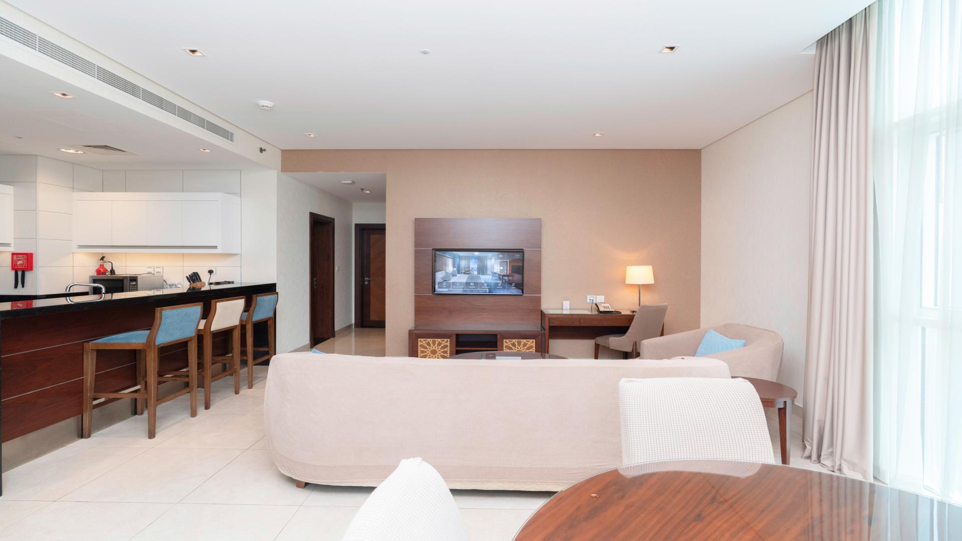 Modern furnished living room in Business Bay apartment, featuring city views and elegant decor