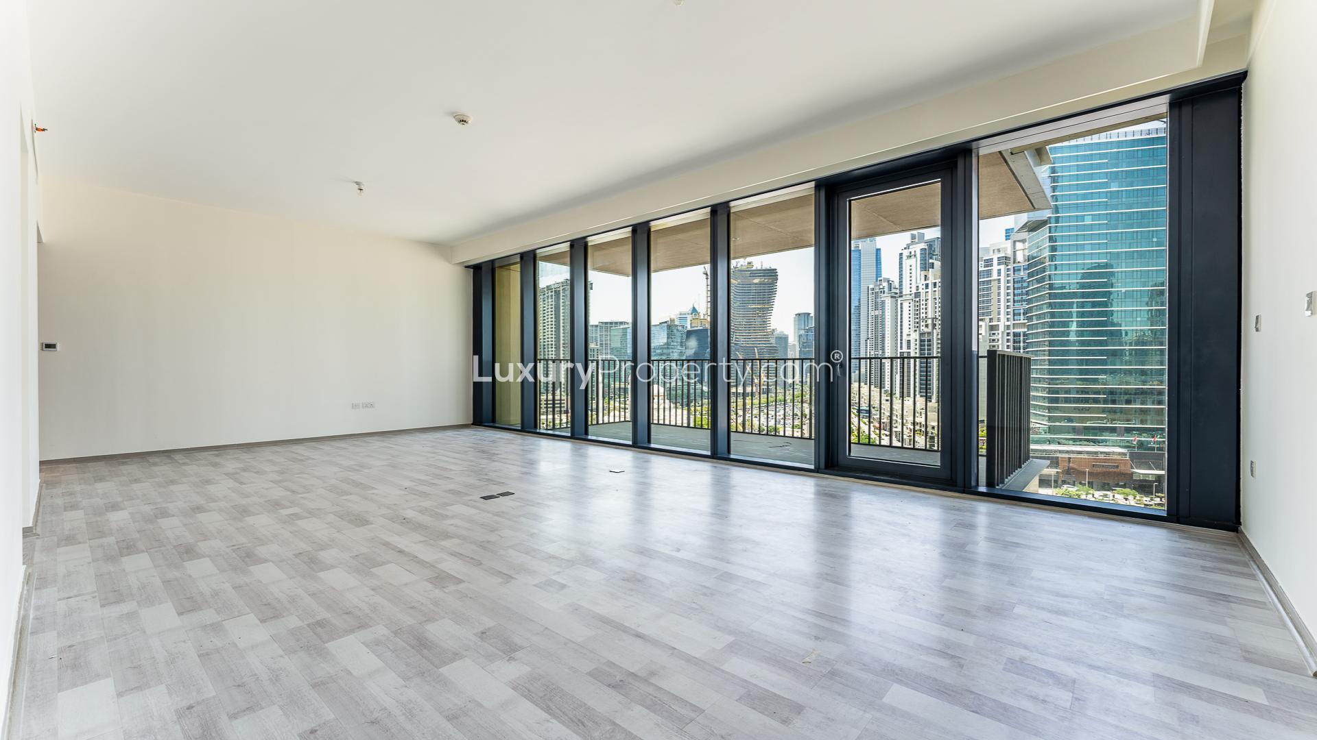 Bright living room with floor-to-ceiling windows in BLVD Heights Tower 1 apartment, Downtown Dubai