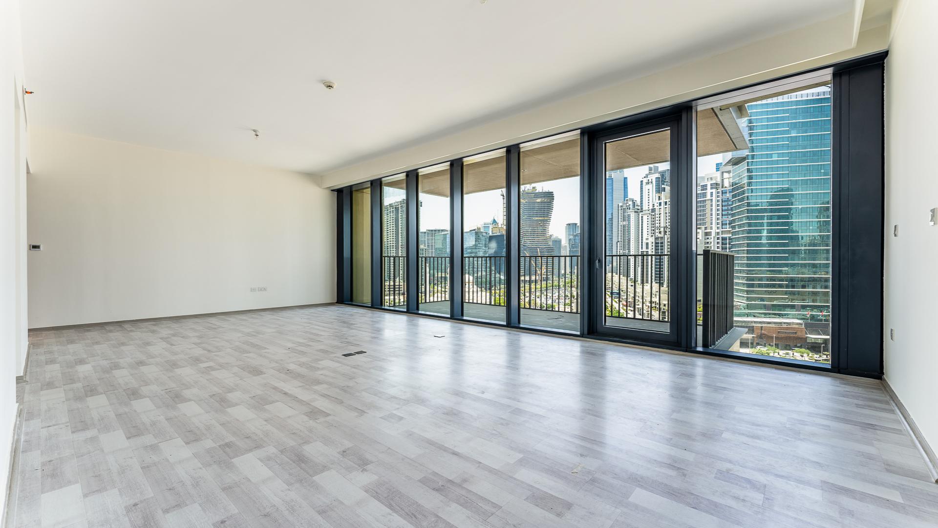 Bright living room with floor-to-ceiling windows in BLVD Heights Tower 1 apartment, Downtown Dubai