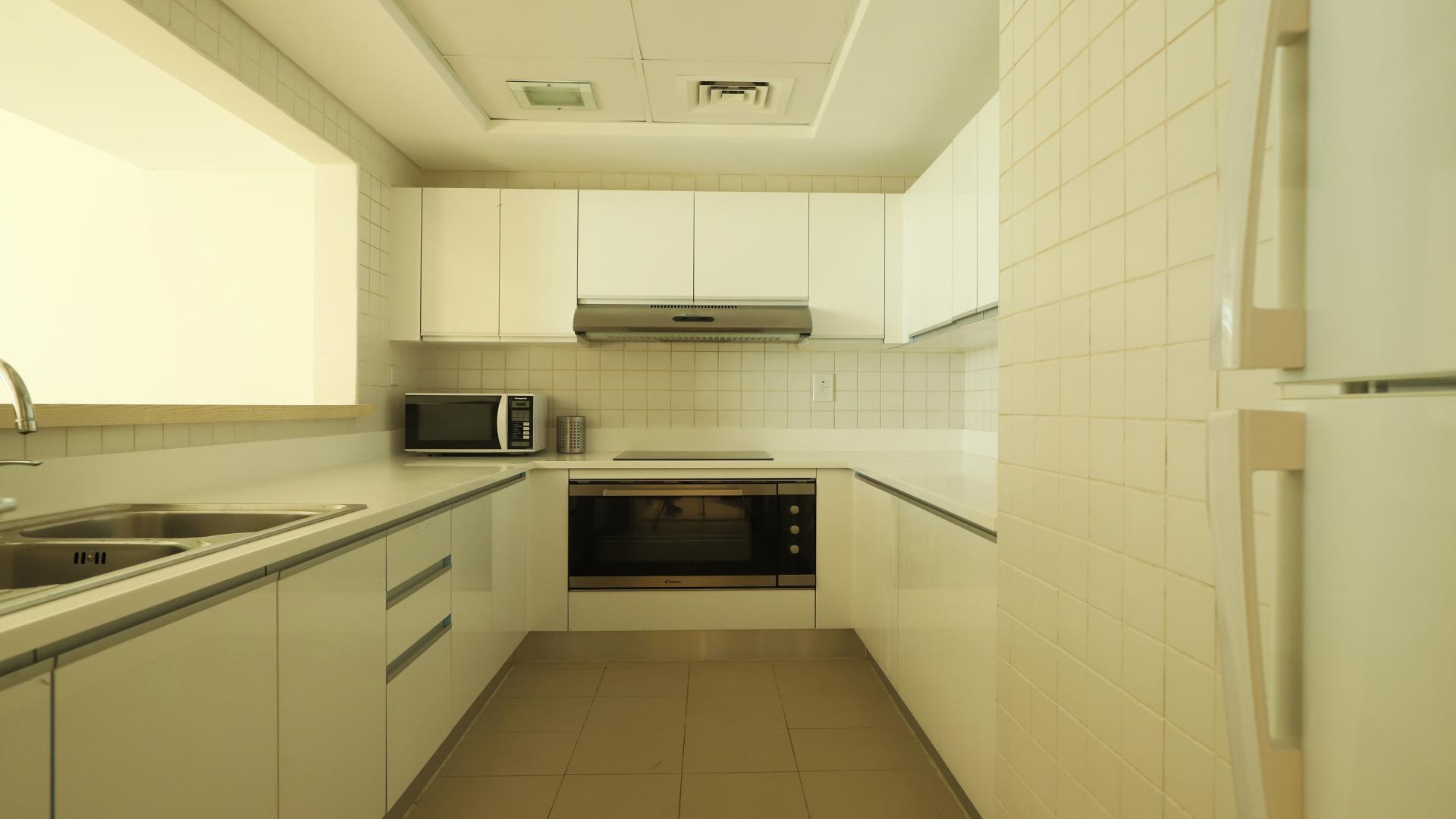 Dining area in two-bed JBR apartment, Al Bateen Residences, with modern furniture and decor