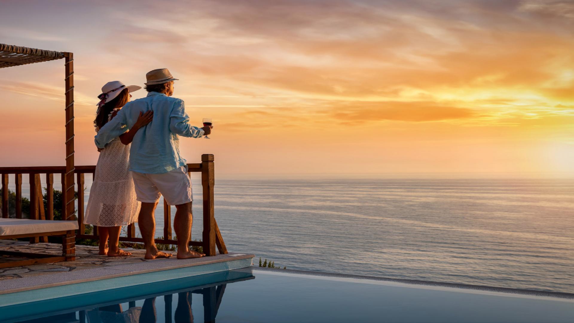 Couple enjoying sunset view from luxury apartment in Mina Rashid, overlooking the ocean