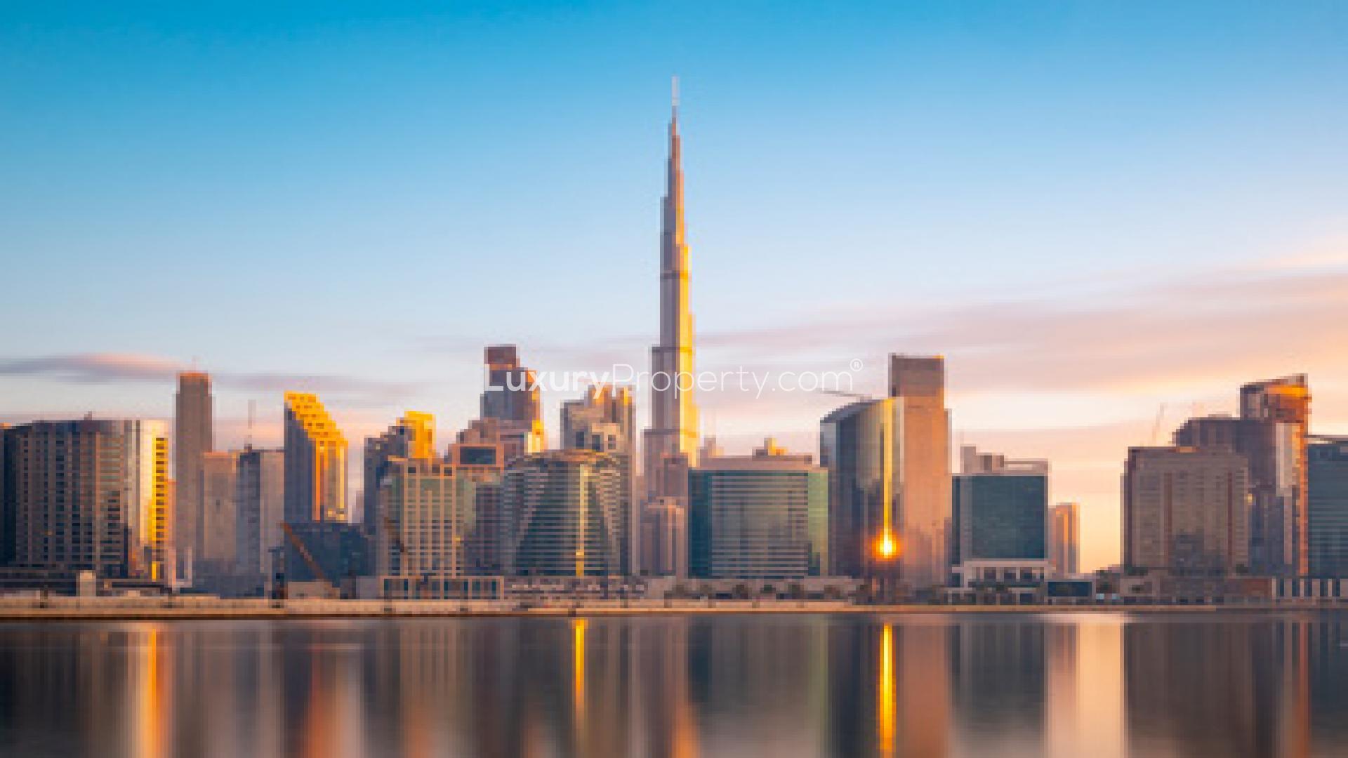 Skyline view near Mina Rashid, featuring modern architecture and waterfront reflections at sunset