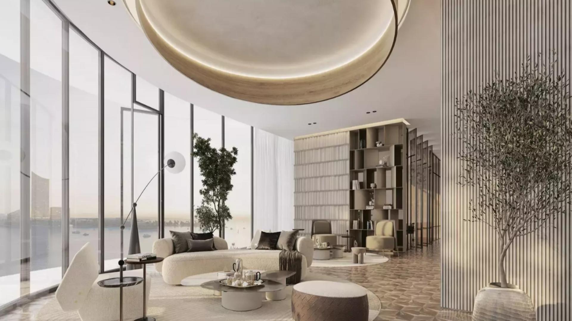 Modern open-plan living room and kitchen in Ellington Views apartment, Al Hamra Village