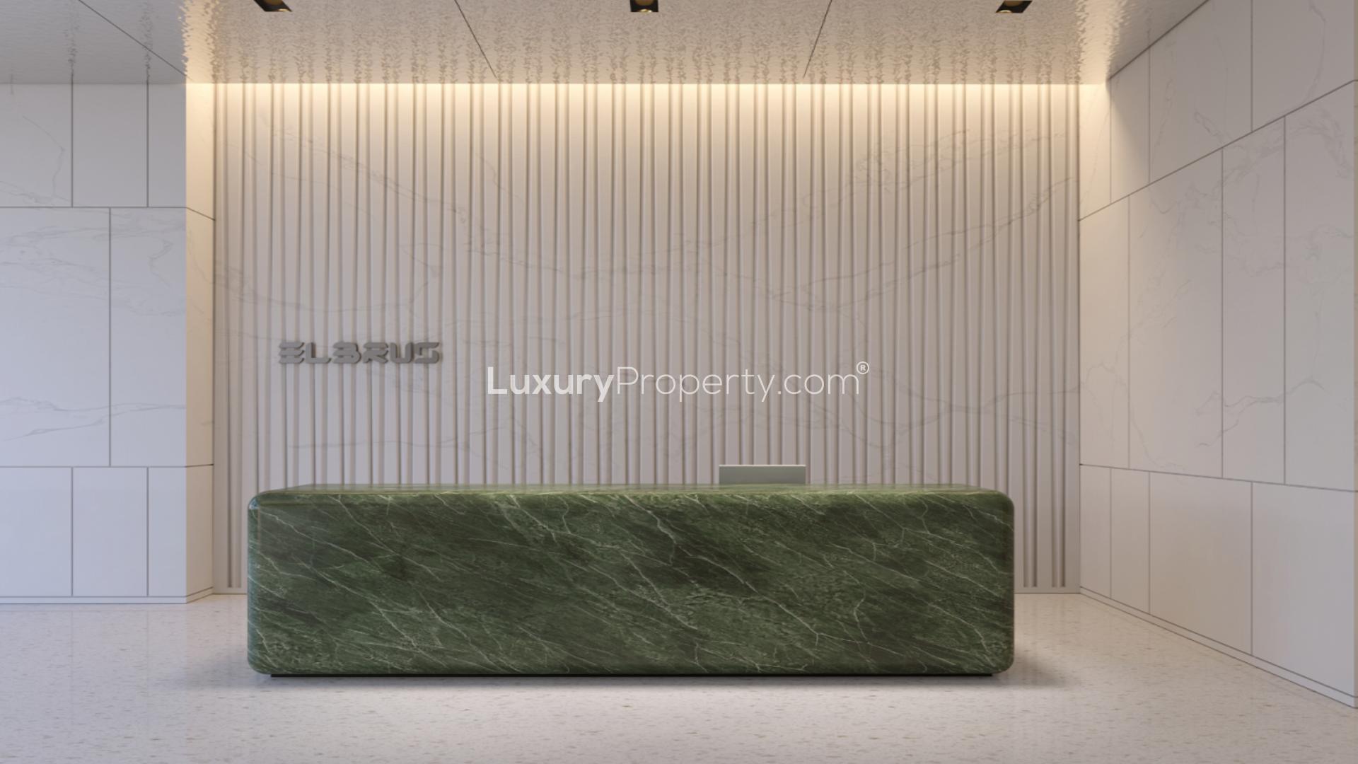 "Elegant lobby in Elbrus Tower apartment, featuring modern green and white decor.","Modern lobby in Elbrus Tower, Jumeirah Village Triangle apartment for sale, LP39199.",Outdoor pool area at Elbrus Tower, Jumeirah Village Triangle apartment for sale