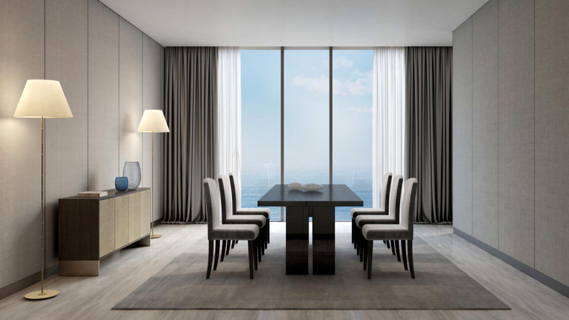 "Armani Beach Residences luxury apartment with beachfront view, Palm Jumeirah, for sale.",Dining area in Armani Beach Residences apartment, Palm Jumeirah, with ocean view