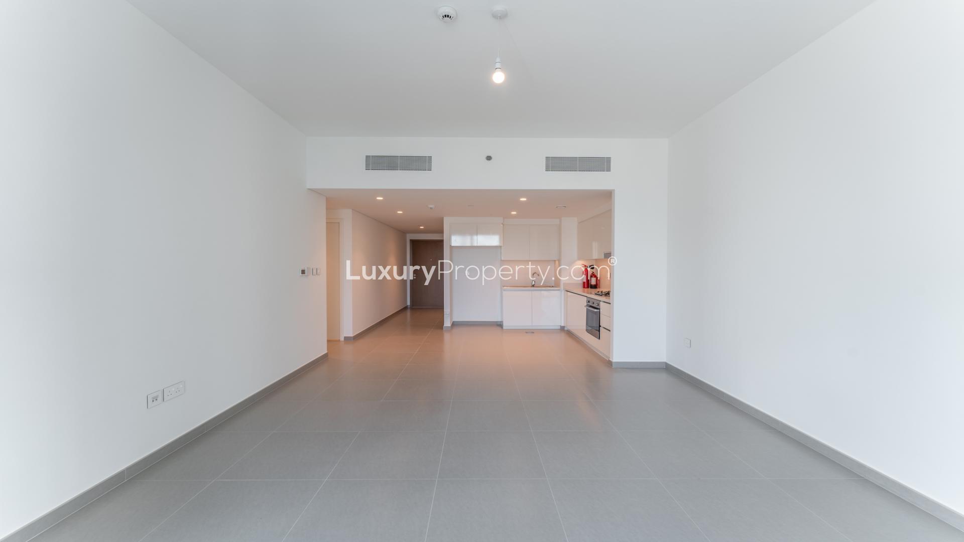 Modern kitchen in Downtown Dubai apartment, featuring sleek white cabinets and built-in appliances