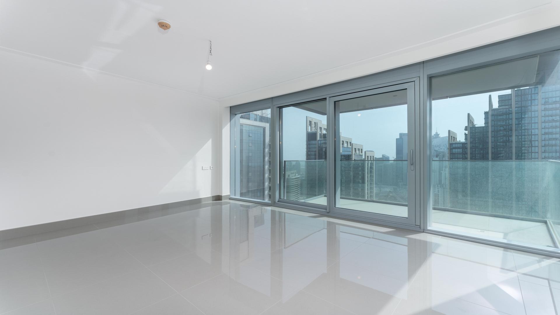 Empty modern apartment interior in Opera District, Downtown Dubai, with large windows and sleek design