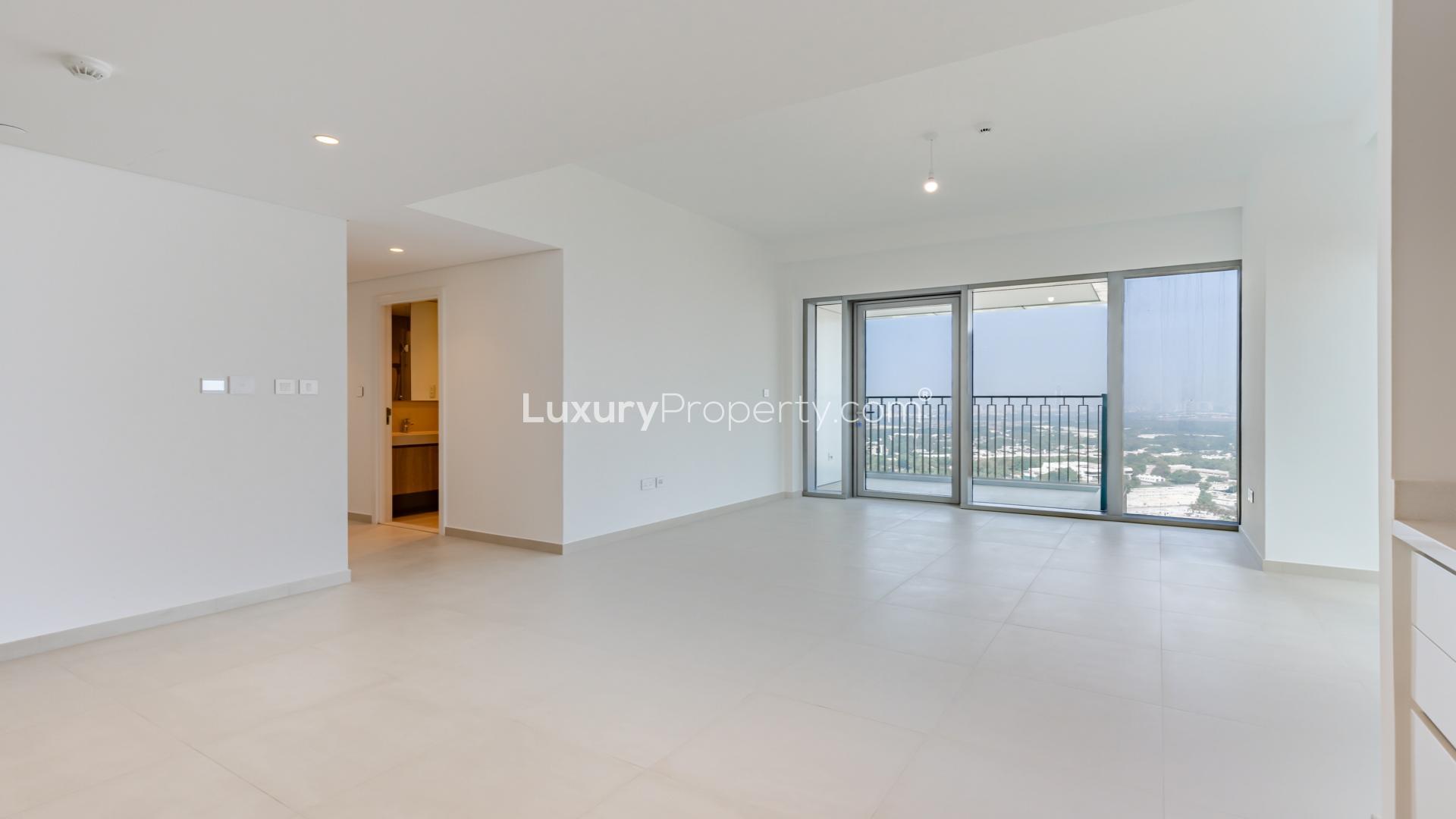 Alt text: "Bright living room with floor-to-ceiling windows in Downtown Dubai apartment, stunning city views.",Spacious living room in 2-bedroom apartment, Downtown Views II, Downtown Dubai for sale