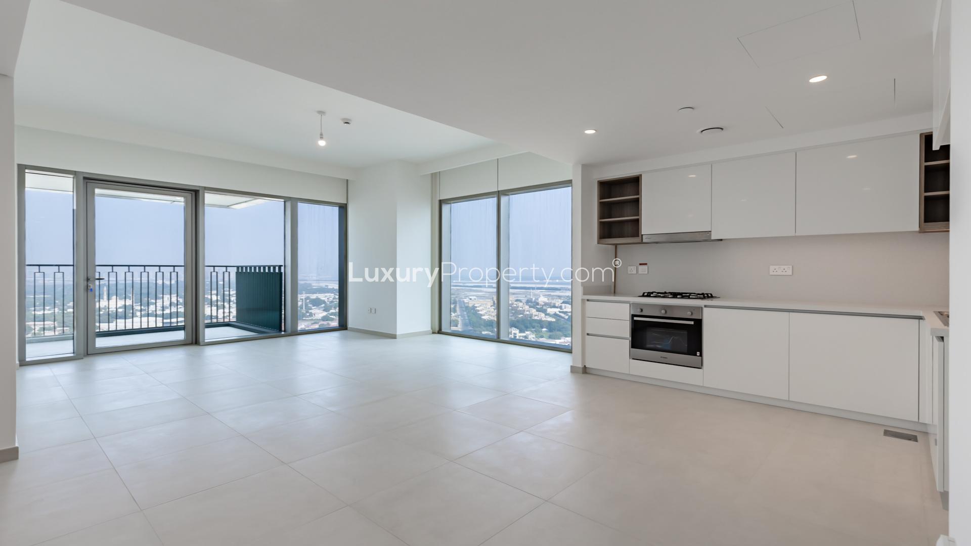 Modern open-plan kitchen and living area in Downtown Dubai apartment, large windows, bright interior