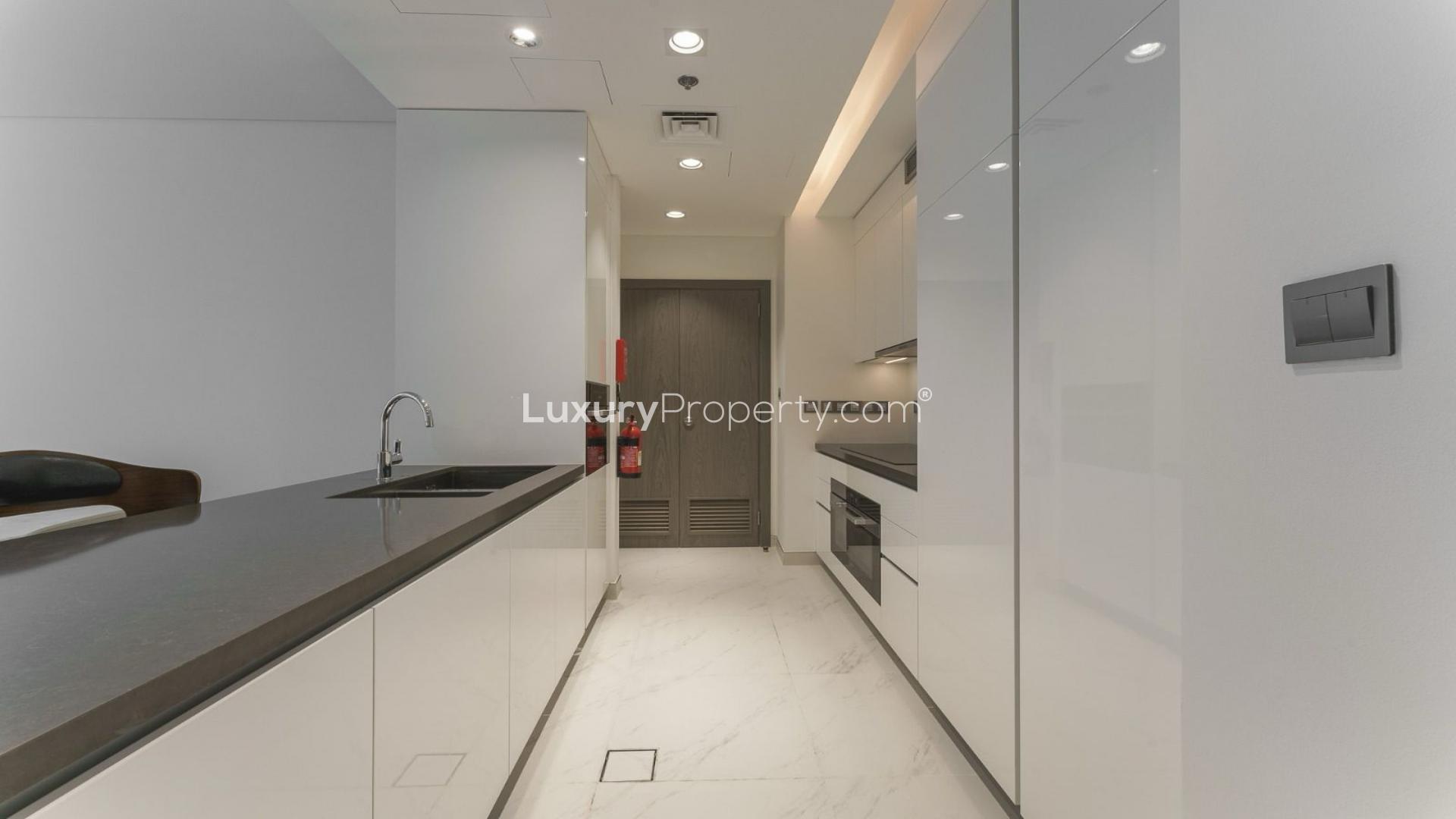 Furnished apartment kitchen and living area with lagoon view in District One, MBR City