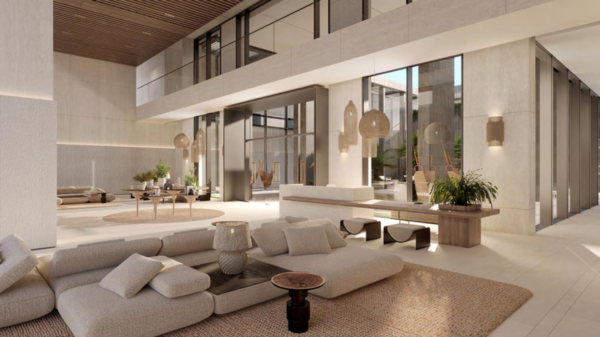 Luxurious lobby of Playa Del Sol apartment, Al Marjan Island, with modern decor and plants