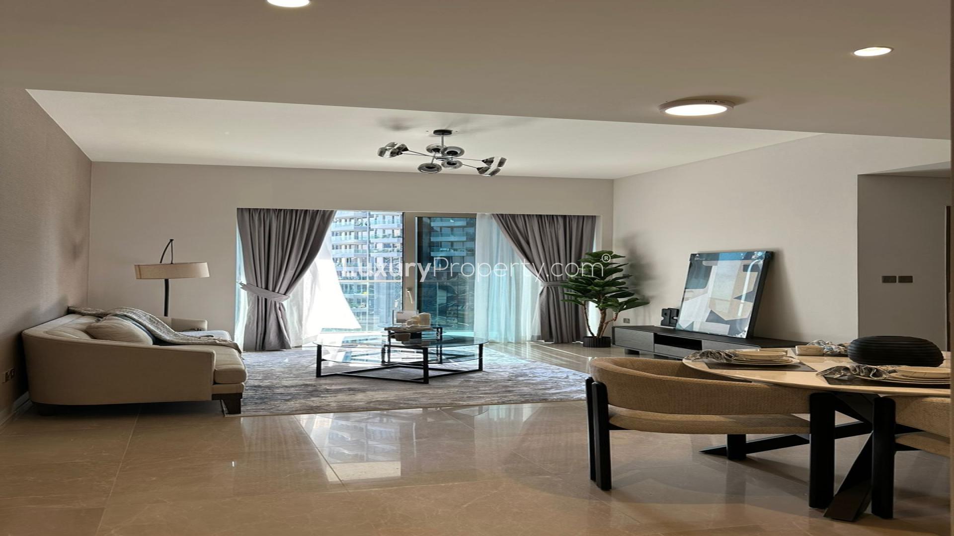 Modern living room in brand new Downtown Dubai apartment with lake and sea views