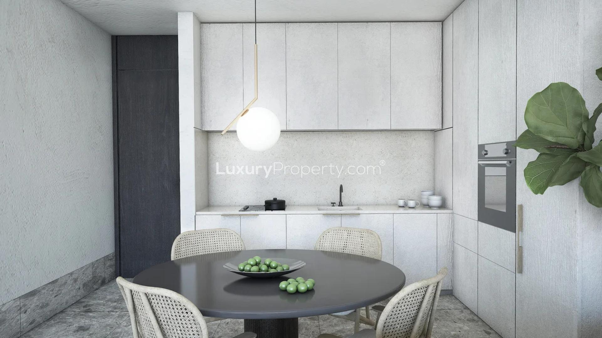 Modern living room with balcony view in Mediterranean-inspired Iliso Suites apartment, Athens Riviera