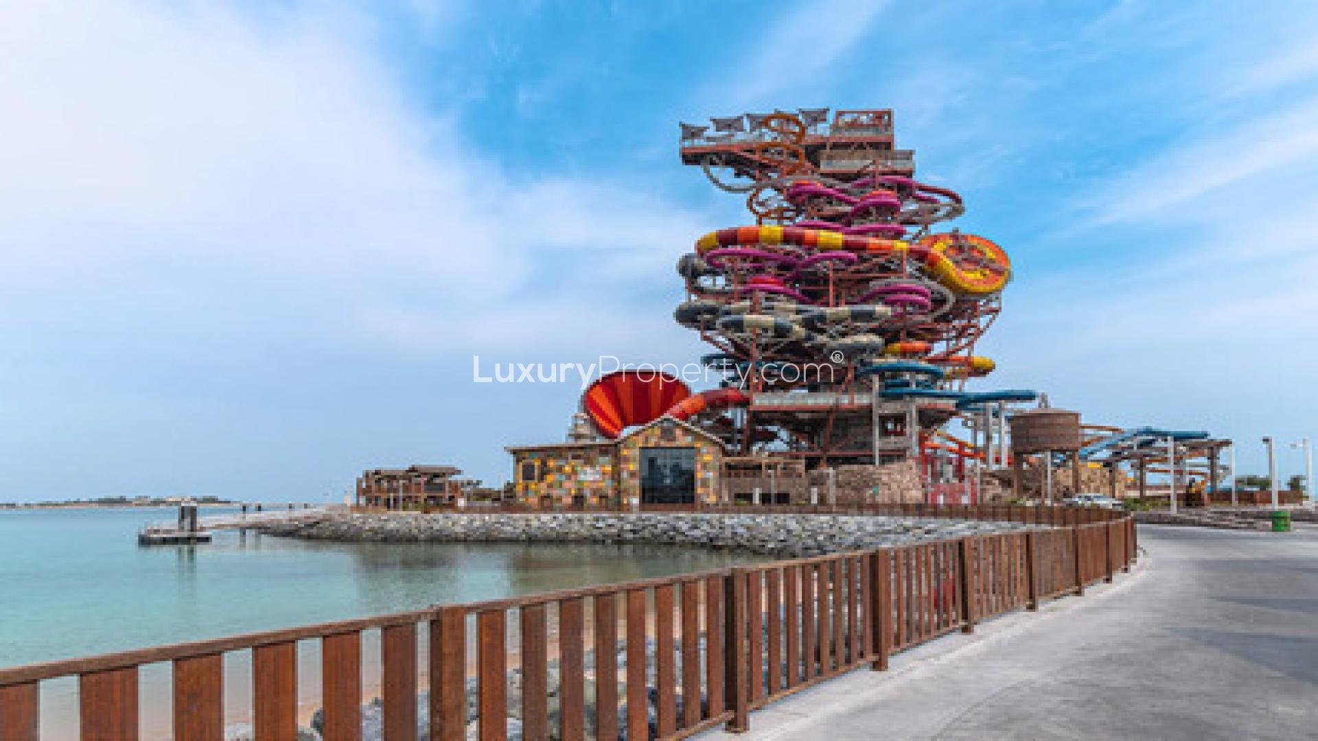 "Luxurious ocean-view terrace at L Horizon by Elie Saab, Qetaifan community apartment.",Oceanfront view near L Horizon by Elie Saab, vibrant water park in Qetaifan community