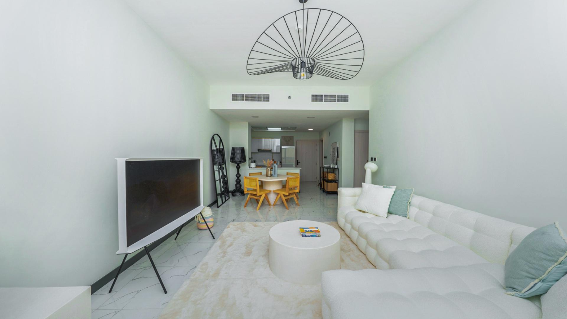 Stylish dining area and modern kitchen in Rukan 1 apartment, Dubai Land