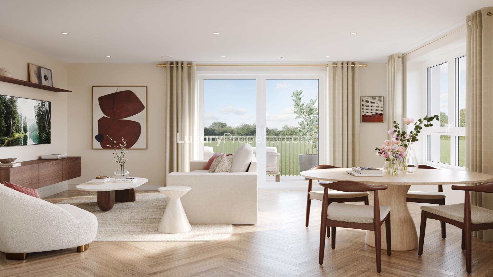 "Modern brick apartment complex with balconies and green park views in Wandsworth Common, London.",Stylish living area in Wandsworth Common apartment with large windows and park views