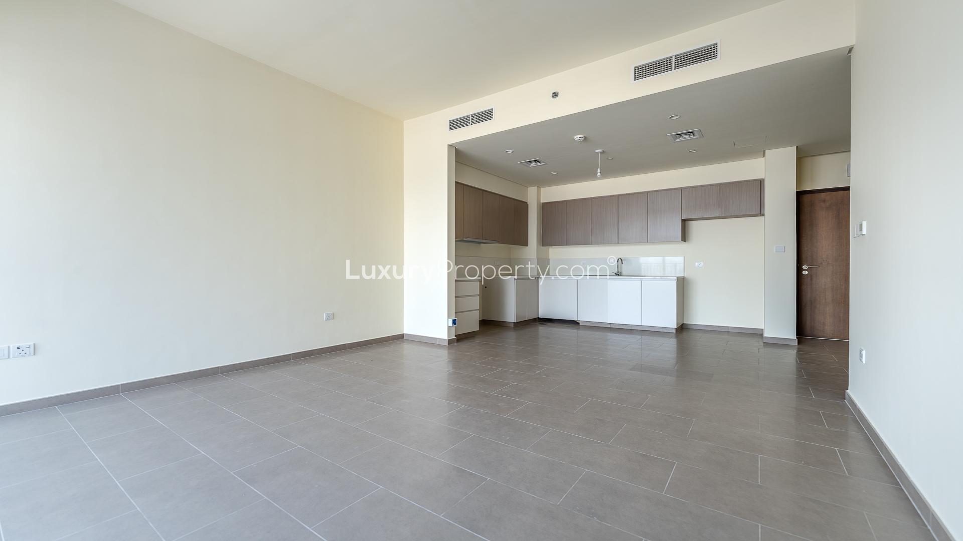 "Modern kitchen in 2-bed apartment, Park Heights, Dubai Hills Estate, ready for sale.",Modern open-plan kitchen and living area in 2-bed apartment, Park Heights, Dubai Hills