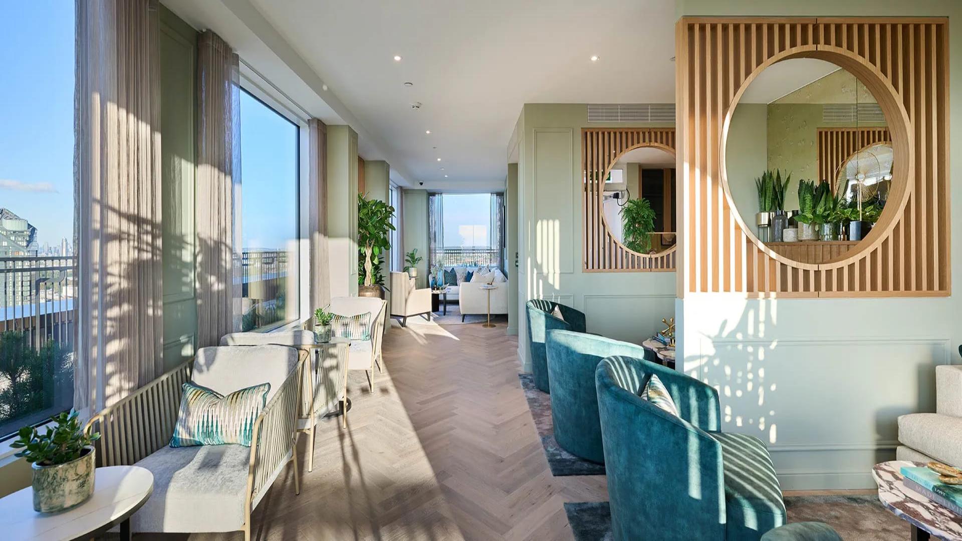 "Elegant Chelsea Creek apartment lounge with modern decor and large windows overlooking the boulevard.",Modern kitchen and dining area in Chelsea Creek apartment, London, with elegant decor