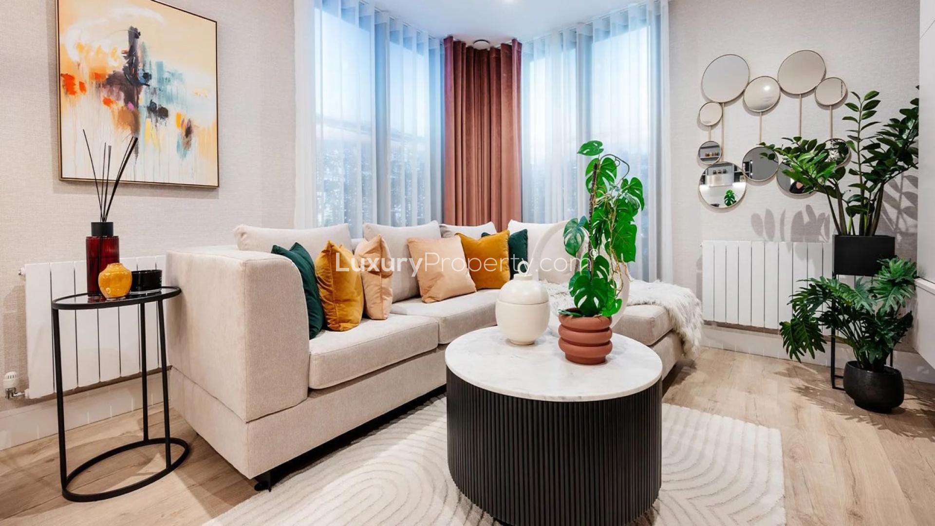 Cozy bedroom in Evergreen Point apartment, TwelveTrees Park, London, with modern decor and window view