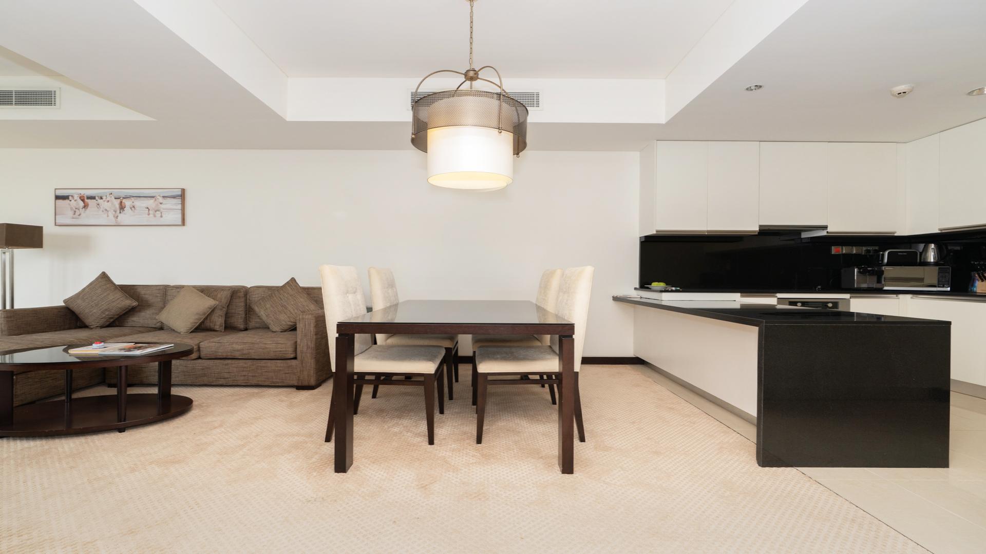 Luxurious living room in high-floor apartment, Dubai Marina, with balcony and city views