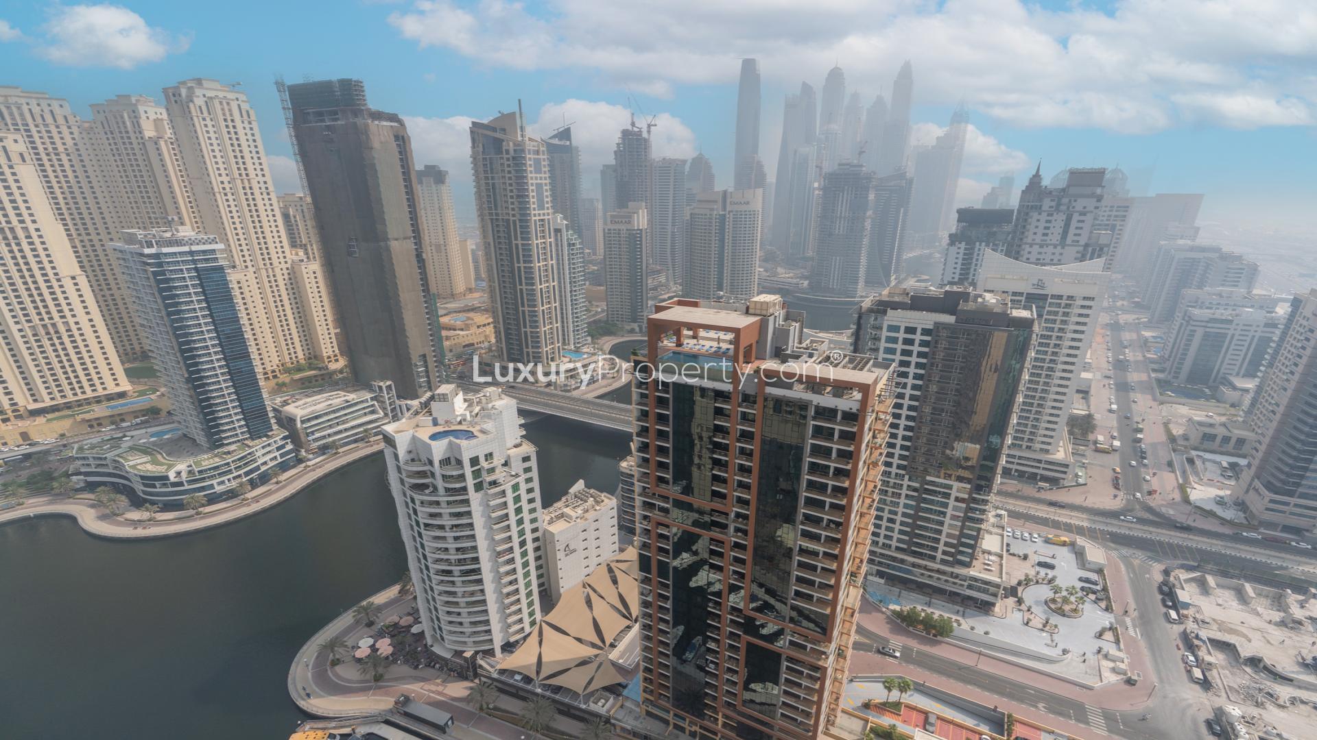 Modern living room in Dubai Marina apartment, featuring elegant furniture and open kitchen layout