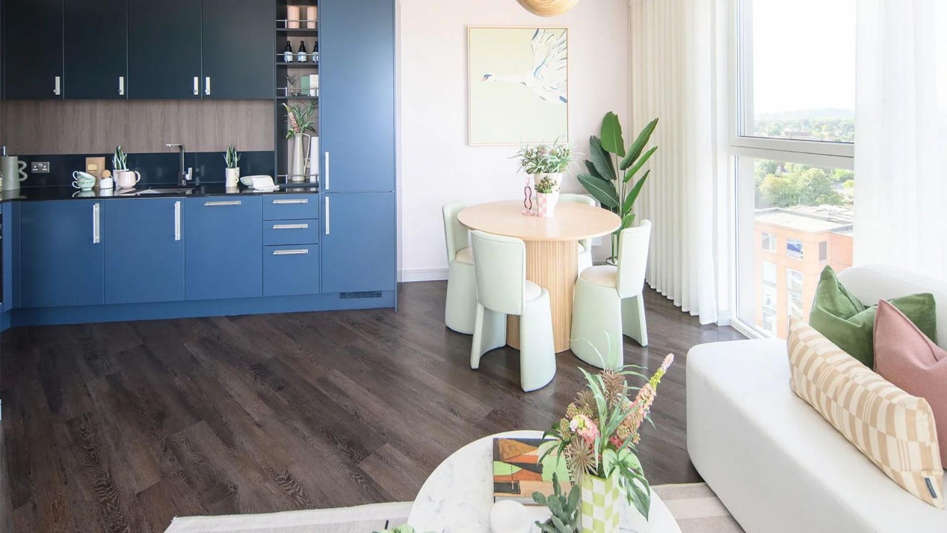 "Modern apartment exterior with landscaped gardens in Lavender House, Eden Grove, London, for sale.",Modern kitchen and dining area in Lavender House apartment, Staines, with large window views