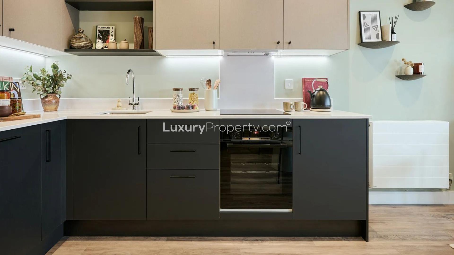 Balcony view from Bankside Gardens apartment overlooking serene lake and modern architecture