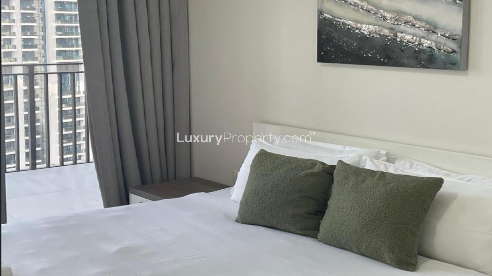 Modern bedroom with balcony view in BLVD Crescent, Downtown Dubai apartment for sale