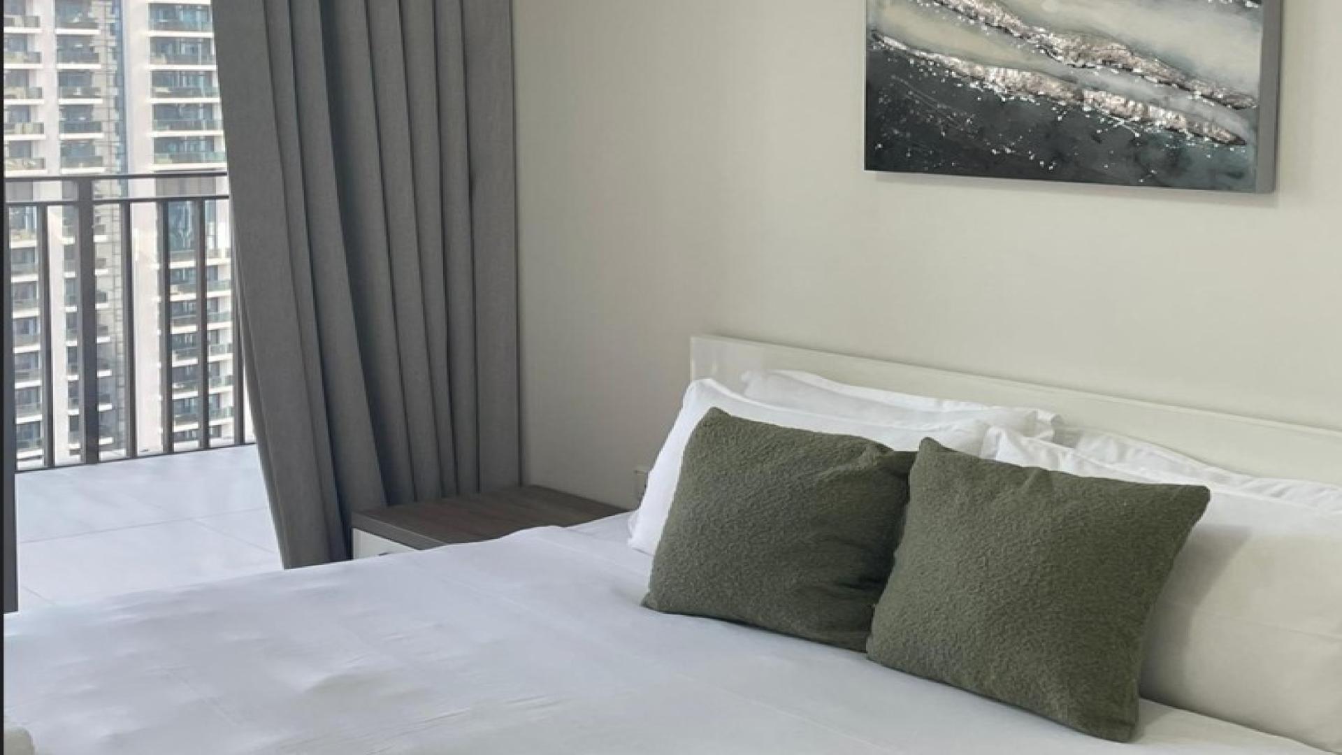 Modern bedroom with balcony view in BLVD Crescent, Downtown Dubai apartment for sale